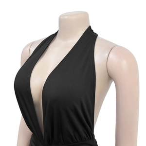 Detail of sexy deep V-neck halter dress in black stretch fabric with side slit design