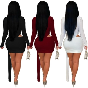 Rear view of long sleeve mini dress featuring side cut-outs and elegant side streamers