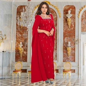 Detail of red formal gown with luxury crystal collar and elegant cape sleeve design
