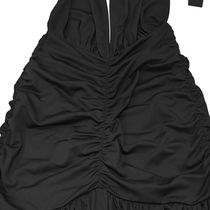 Close-up of ruched front detailing and soft black fabric texture of the halter dress