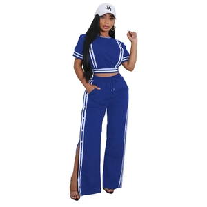 Dettaglio del completo blu navy a due pezzi con strisce bianche laterali e bottoni d'argento