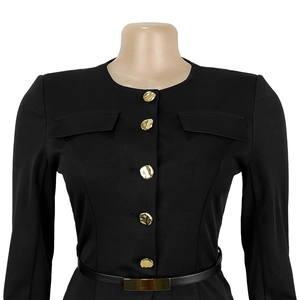 Dettaglio completo di abbigliamento nero con bottoni dorati e cintura sottile in vita