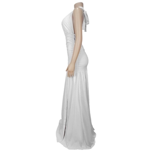 Detail of white halter neck maxi dress featuring side pleats and elegant high slit
