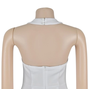 Detail view of white halter dress featuring a backless design and invisible zipper closure