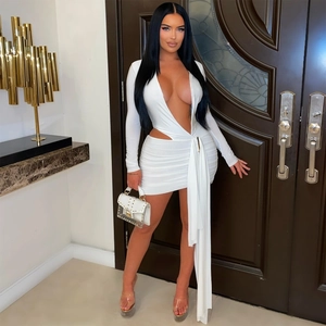 Close-up of deep V-neck white mini dress featuring side waist cut-out and long sash detail