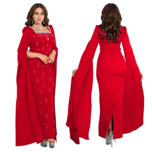 Detail of red cape sleeve dress showing square neckline with sparkling diamond embroidery