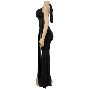 Detail of a black halter neck long dress featuring sheer mesh waist and ruched fabric design
