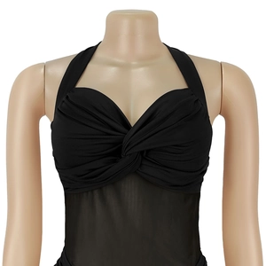 Detail of the black halter dress featuring a twist-front chest design and sheer mesh panel
