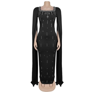 Detail of elegant black evening gown featuring silver rhinestones and long cape sleeves