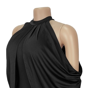 Close-up of elegant black halter neck dress featuring pleated high collar and draping details