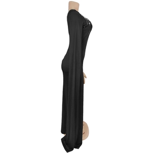 Close-up of elegant black dress featuring rhinestone neckline and dramatic floor-length sleeves