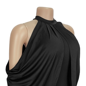 Detailed close-up of the elegant draped halter neckline on a sleek black sleeveless dress