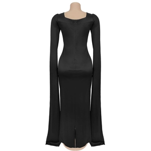 Detail view of the elegant back zipper and split hem on this black cape sleeve maxi dress