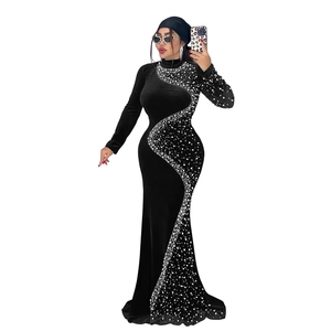 Détail d'une robe en velours noir avec perles en courbe S et ourlet de style sirène