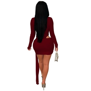 Close-up of a burgundy slim-fit dress with waist cut-outs and side ribbon detail