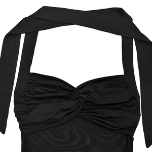 Detail of black halter dress with mesh patchwork and ruched knot design elements