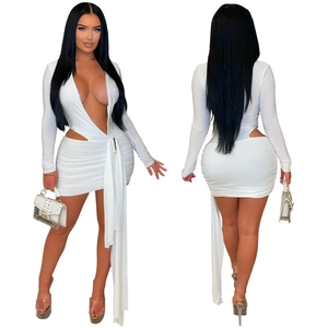 Detail showing the deep V-neckline and waist cutouts on this white long sleeve dress