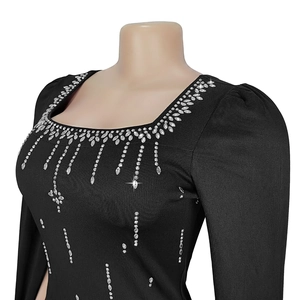Detail of square neckline with silver rhinestones and fringe sequins on black dress
