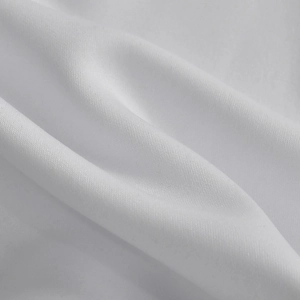 Close-up of premium white knitted fabric texture with soft drapery and fine weave detail