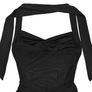 Detail of black halter neck mesh dress featuring a twisted knot neckline and sheer fabric