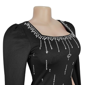 Detail of elegant black dress with shimmering silver rhinestones along the square neckline