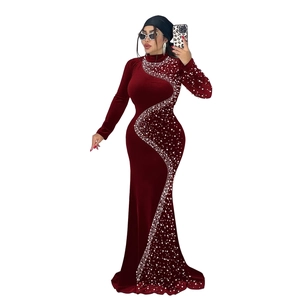 Détail d'une robe de soirée en velours bordeaux avec motif élégant en strass argentés en S