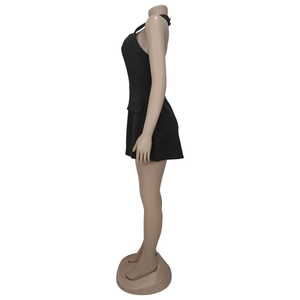 Side view detail of a black sleeveless mini dress with decorative faux side pocket flaps