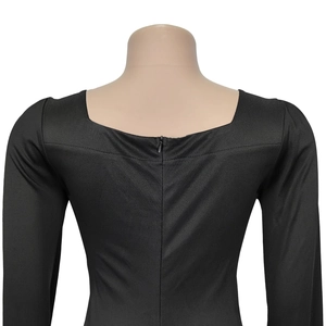 Detail view of black elegant dress featuring square neckline and invisible back zipper