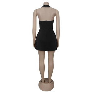 Detailed back view of a black halter mini dress featuring an open back and hidden zipper