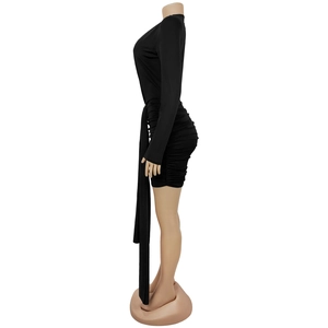 Detail view of black long sleeve ruched dress with side ribbons and high neckline
