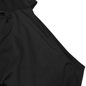 Macro detail of the smooth black knit fabric and precise flatlock stitching on the shoulder