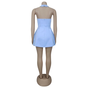 Detail view of the back zipper closure and halter neck buckle on the light blue mini dress