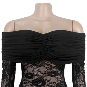 Detail of black off-the-shoulder top with elegant floral lace sleeves and pleated texture