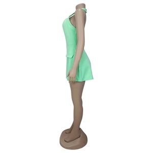 Detail view of mint green halter neck backless mini dress with decorative side flap pockets
