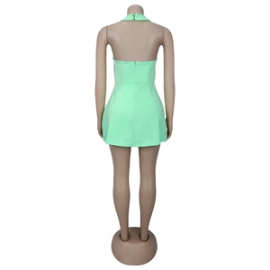 Detail view of the mint green halter dress back featuring an open back and hidden zipper