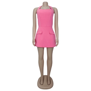 Front detail of pink sleeveless halter dress featuring flap pockets and structured fabric