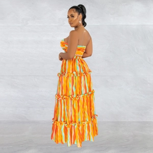 Detail view of the tiered skirt layers and colorful vertical stripe print on summer dress