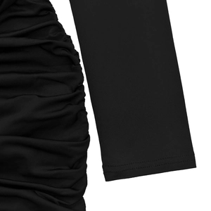 Detail of ruched side texture and long sleeves on a black solid color dress