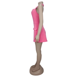 Detail view of pink halter neck mini dress featuring tailored side flap and slim fit cut