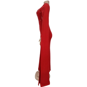 Detail of red floor-length gown featuring dramatic cape sleeves and silver rhinestone starburst