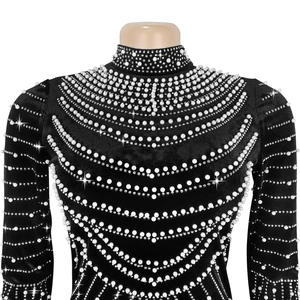 Dettaglio del vestito in velluto a collo alto con ricami di perle e strass fatti a mano