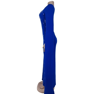 Detail of elegant dark blue fitted dress featuring star rhinestones and floor-length sleeves