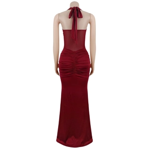 Detail of the back view showing sheer mesh splicing and ruched burgundy halter maxi dress