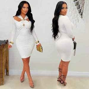 Détail d'une robe blanche moulante avec décolleté croisé et boutons dorés métalliques
