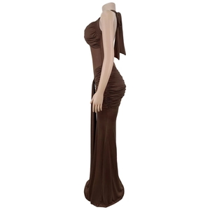 Detail of ruched texture and open back on a deep brown halter neck maxi evening dress