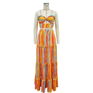 Detail of bohemian two-piece set with sleeveless crop top and layered striped maxi skirt