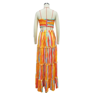 Back view of a colorful striped two-piece set featuring a tiered maxi skirt on a mannequin