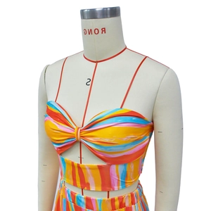 Detailed shot of multi-color striped strapless crop top with twist knot front design