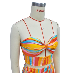 Detailed view of colorful striped strapless top with front twist knot and waist cutout