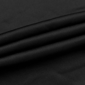 Dettaglio macro della trama in velluto nero che mostra maglieria fine e morbidezza